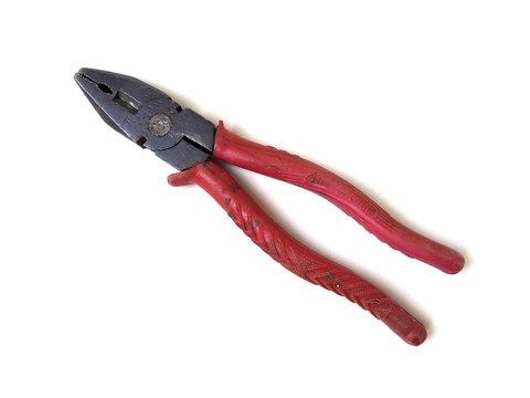 Close up of red handle old rusty pliers isolated on white background. Hand tool.
