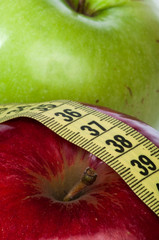 Red and green apple and centimeter