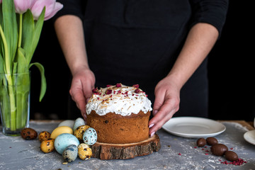 Easter composition with sweet bread, kulich and eggs on light background.