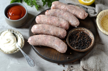 Raw homemade sausages from turkey (chicken) with different sauces