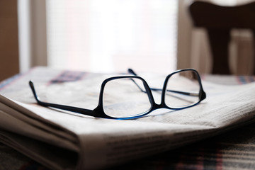 glasses on a newspaper 