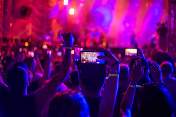 a group of fans raised their hands up at a music concert