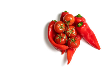 Red pepper with a branch of tomato on a white background. 
