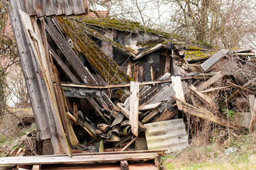 old wooden hut broken down on a farmyard