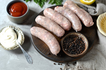 Raw homemade sausages from turkey (chicken) with different sauces