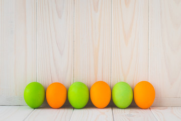 Paschal template with text space. Painted easter eggs on light wooden boards. Holiday gift card in laconic style.