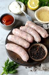 Raw homemade sausages from turkey (chicken) with different sauces
