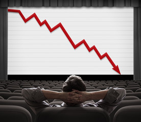 Man sitting and looking on screen with financial diagram