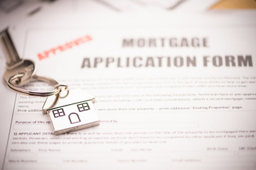 An empty mortgage application form with house key business working concepts