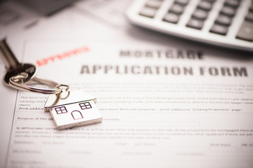 An empty mortgage application form with house key business working concepts