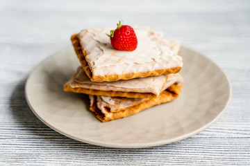 Waffles and strawberries on a grey wooden background. Dessert with berries.	