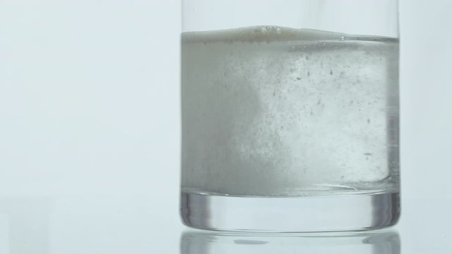 Effervescent powder dropped in to a glass of water. 4K resolution. High quality audio recorded with condenser microphone.