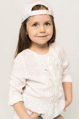 Cute girl 5-6 year old posing in studio.