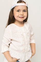 Cute girl 5-6 year old posing in studio.