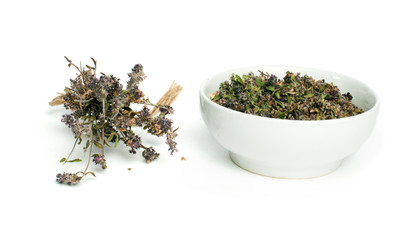 Dried thyme in a bowl and thyme twigs