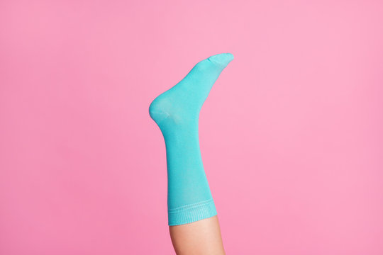 Cropped Close-up View Of One Nice Single Leg Wearing Blue Soft Cotton Bright Sock Isolated Over Pink Pastel Color Background