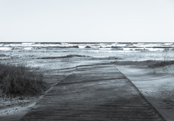Wooden Walkway at a Baltic Sea Beach with Waves in the Winter