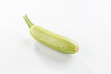single fresh whole green zucchini isolated on white background with shadow