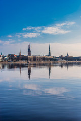Fototapeta premium Cityscape of Riga Latvia with Reflections on a Quiet Still River