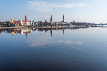 Fototapeta premium Cityscape of Riga Latvia with Reflections on a Quiet Still River