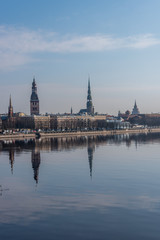 Fototapeta na wymiar Cityscape of Riga Latvia with Reflections on a Quiet Still River