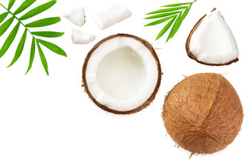 half coconut with green leaves isolated on white background top view