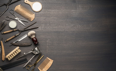 Classic grooming and hairdressing tools on wooden background.