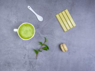 matcha latte with leaf, green chocolate, macaroon