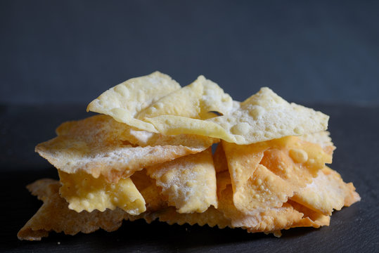 traditional carnival pastry on black background with chocolate chips