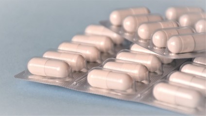 blisters with white tablets on a blue background, medical theme