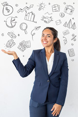 Woman showing copy space with hand drawn business sketches. Beautiful happy young woman gesturing with hand and smiling at camera. Emotion concept