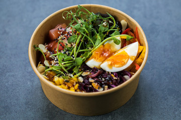 Hawaiian salmon fish poke bowl with, cucumber, tomato, sesame seeds and seaweeds. Diet food