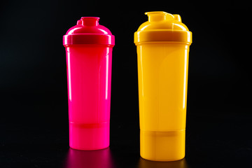 Sport bottle for drink on black background close up