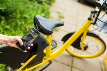 Young girl listen to music and ride a bike in the park with a great mood