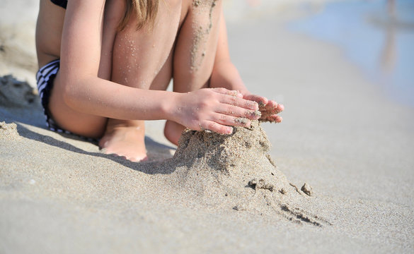 Child legs on sand texture.