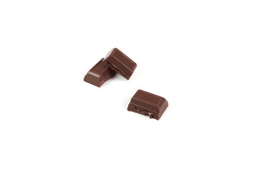 Close-up pieces of chocolate bar with filling isolated on white background.