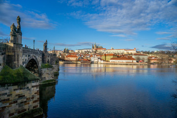 Fototapeta na wymiar A view next to the bridge by the riverbank at Prague