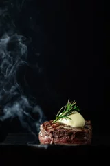 Foto auf Alu-Dibond Cooking beef tenderloin steak on a grill pan on a black dark background with the text copy space. The concept of the recipe, filet Mignon © Andrey