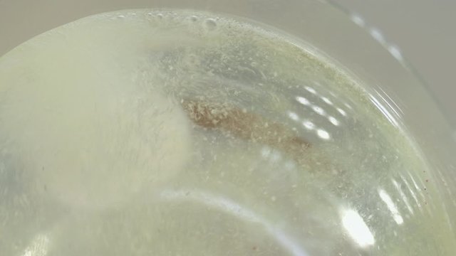 Effervescent vitamin tablet dissolving in glass of water. 4K resolution. High quality audio recorded with condenser microphone.