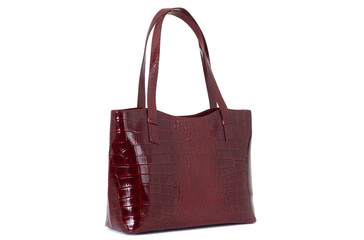 Naklejka premium expensive red female leather bag on a handle isolated on a white background