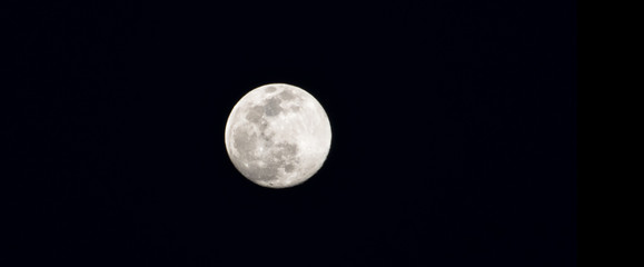 Close-up of full moon on black sky.