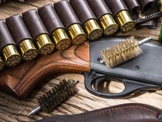 Pump action shotgun, 12 mm hunting cartridge  and hunting knife.