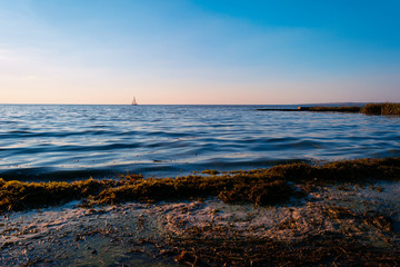 Sailboat in the sea in the evening sunlight. Luxury summer adventure or active vacation concept. Copy space