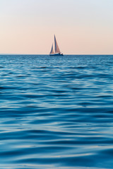 Sailboat in the sea in the evening sunlight. Luxury summer adventure or active vacation concept....