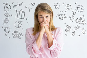 Woman worried about project with hand drawn business sketches. Frowning emotional employee waiting...