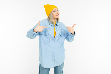 blond girl in a stylish denim shirt and a yellow jacket on a white background