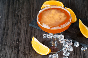 Two beautiful cocktails served on a wooden bar counter