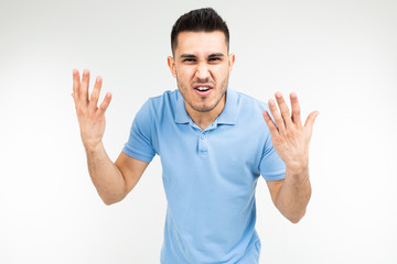 handsome guy in a blue t-shirt screaming at the camera on a white isolated background