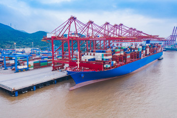 Naklejka premium shanghai container terminal at dusk ,yangshan deep-water port , China