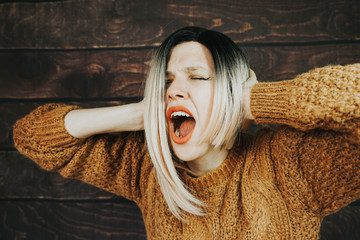 Young stressed woman is screaming